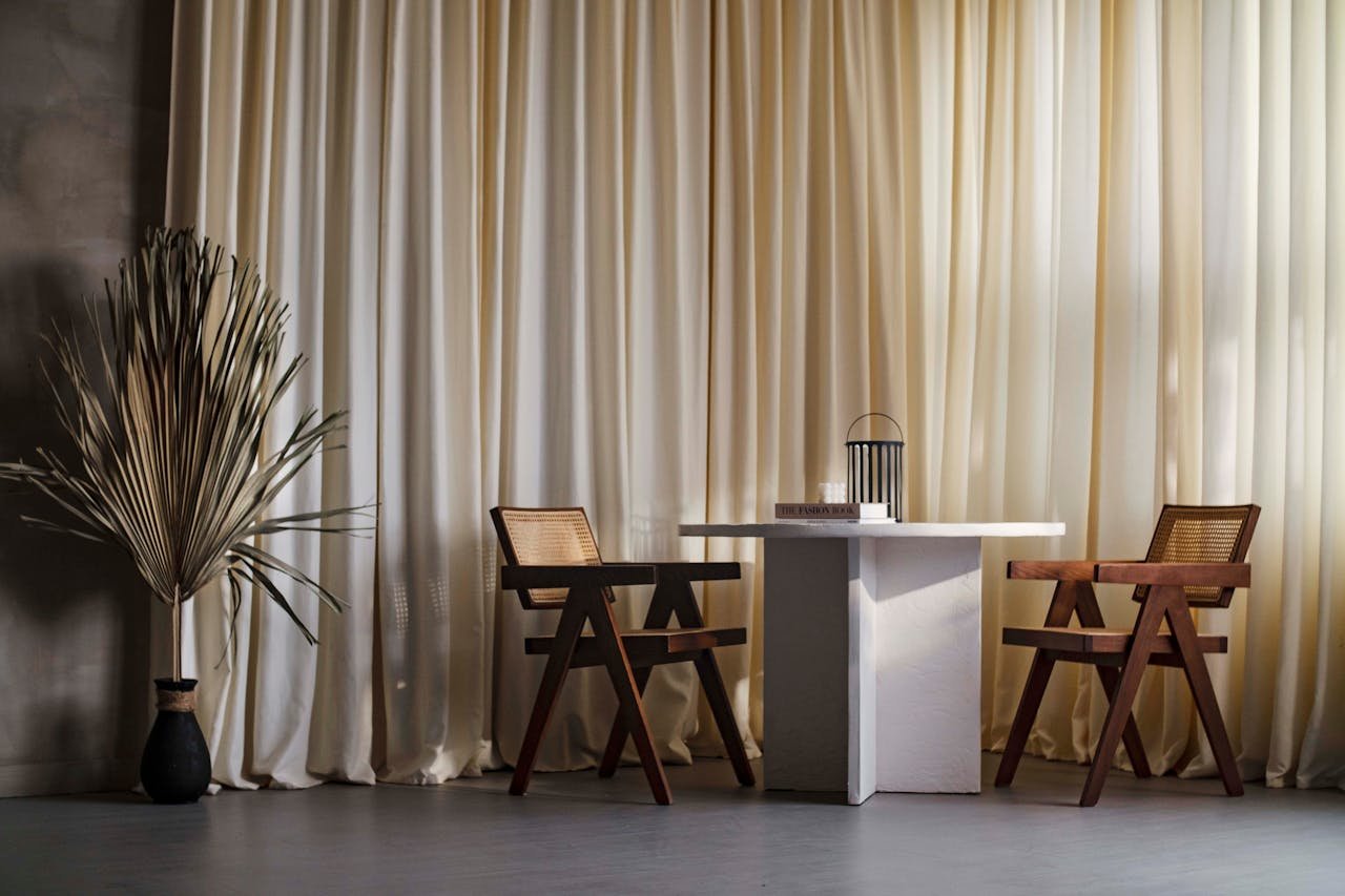 Japandi living room with low profile solid wood furniture neutral linen sofa and warm layered lighting in small space