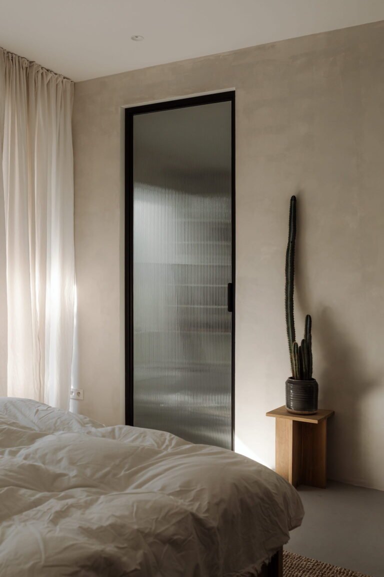 low light bedroom with muted tones and black highlights